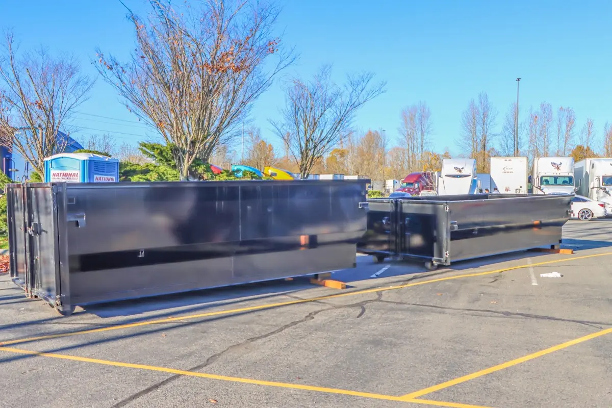 Professional dumpster rental service with roll-off container on residential driveway in Radnor